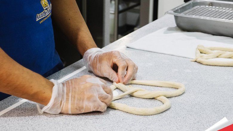 Baker rolling pretzel dough